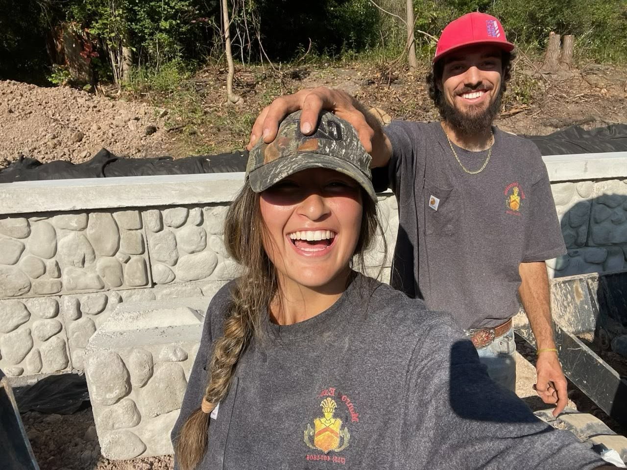 Munro Excavation crew smiling on a retaining wall job site